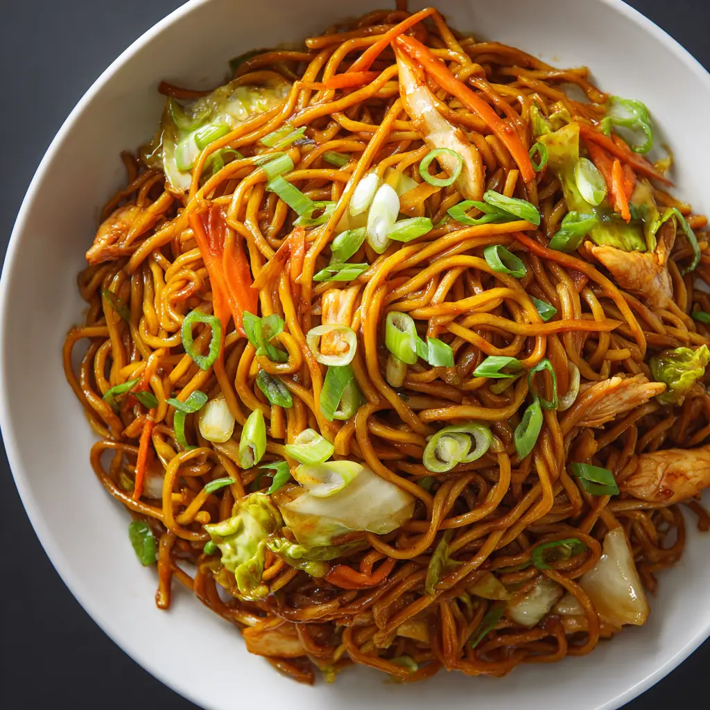 A beautiful final plated Chow Mein Recipe, garnished with sesame seeds and green onions, ready to be served.