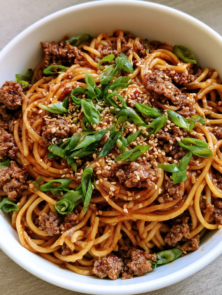 Close up shot of Asian Ground Beef Spaghetti showing the well-browned beef crumbles and glossy soy-chili garlic sauce.
