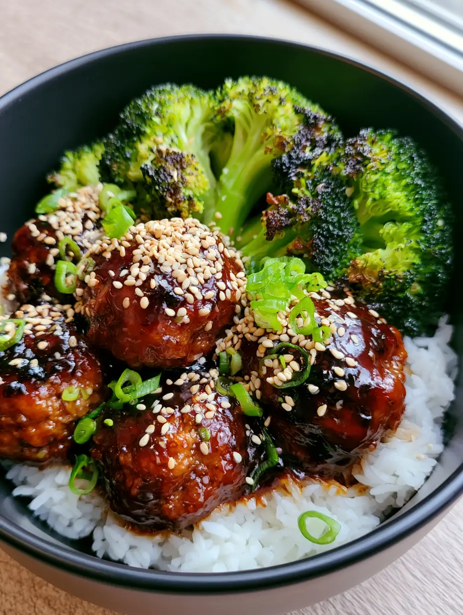 Smartphone photo of seared ground beef meatballs in a thick glossy Mongolian soy glaze with green scallions. (Mongolian Meatballs)
