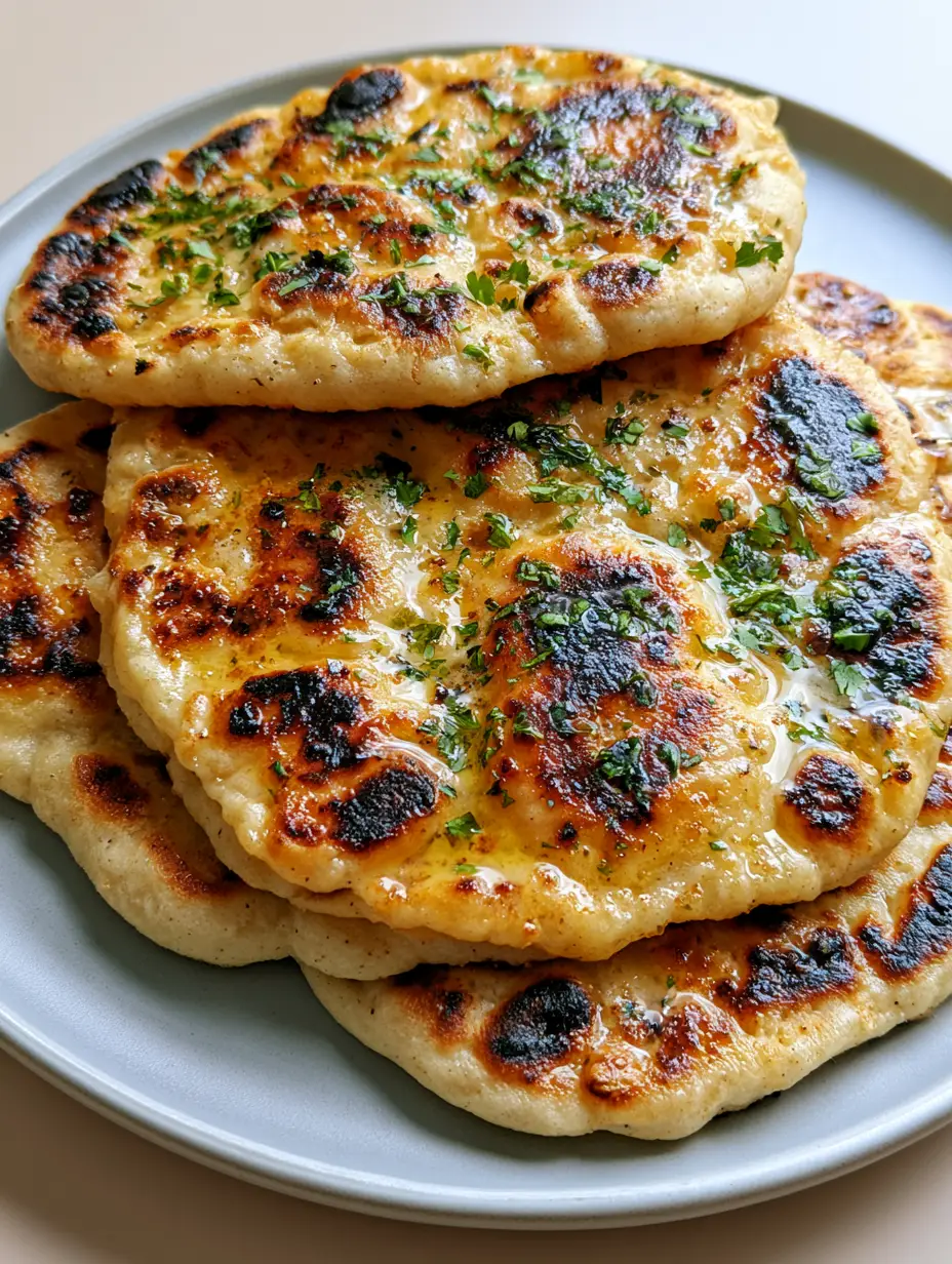 Smartphone photo of yeast-free gluten-free naan with golden-brown bubbles and melted vegan butter. (Gluten-Free Vegan Naan)