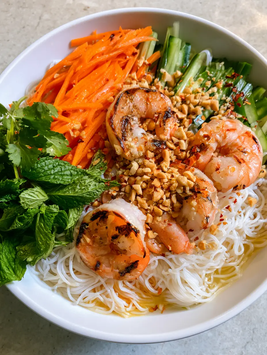 Smartphone photo of Vietnamese Noodle Salad with vermicelli, cucumber, and mint sprigs in a white bowl. (Vietnamese Noodle Salad)